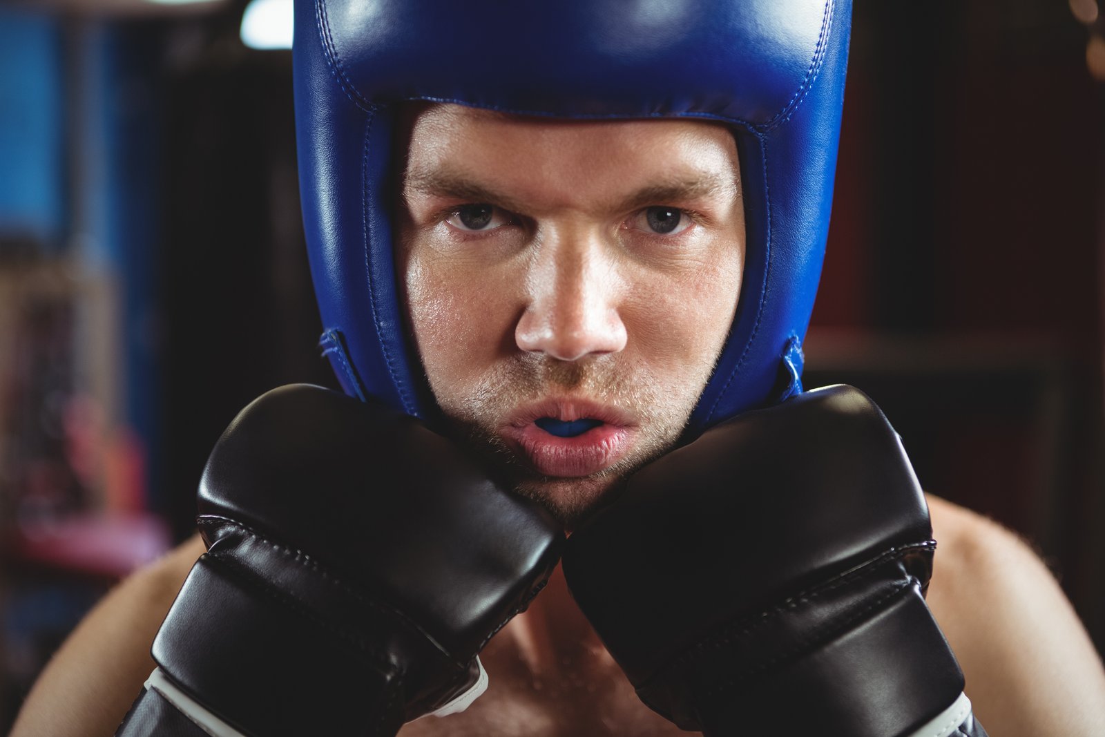 Boxer wearing a custom-fitted mouthguard, demonstrating essential dental protection during sports.