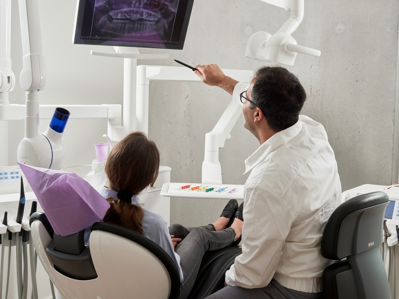 Patient receiving care from a dentist in a modern dental chair
