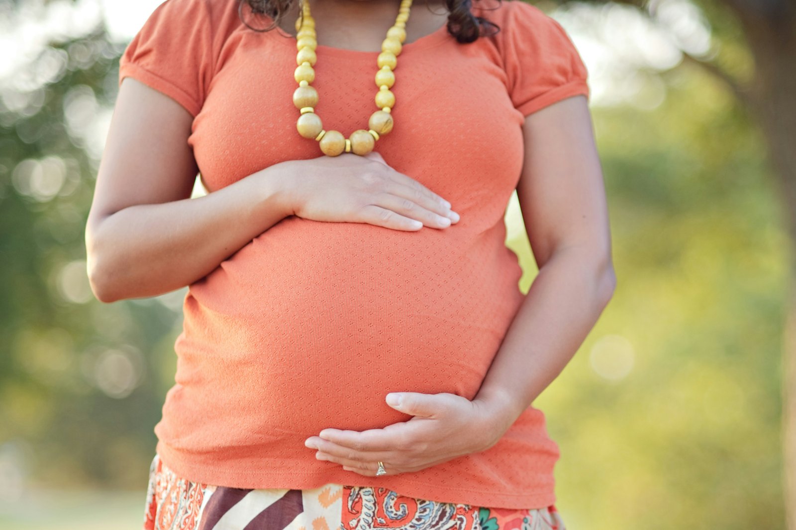 "Pregnant belly, signifying the importance of comprehensive health during pregnancy, including oral care." 